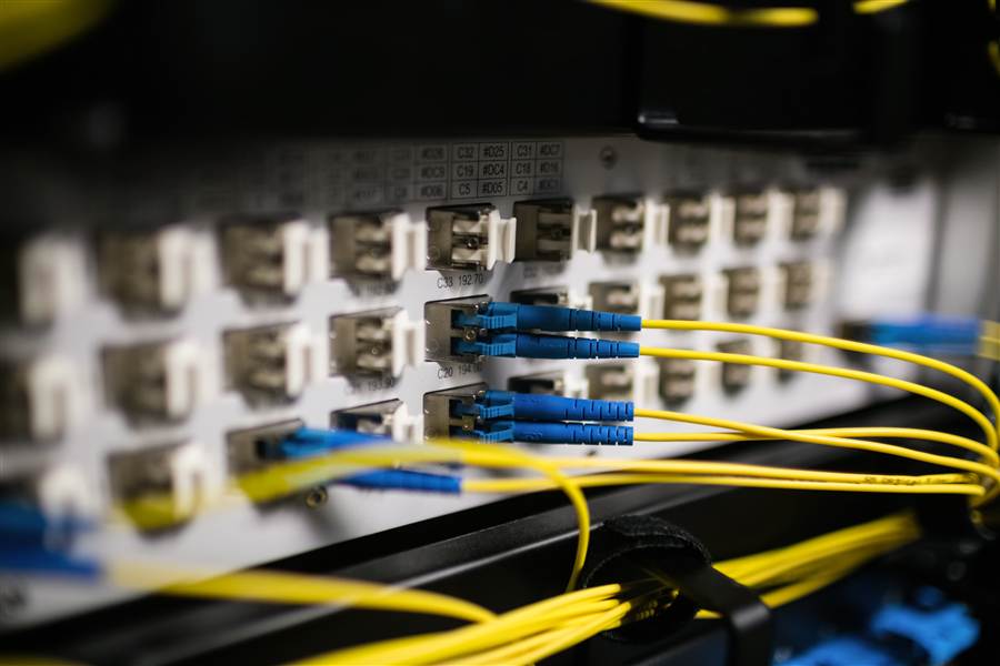 Fiber optic patch cables connected to an SC port panel