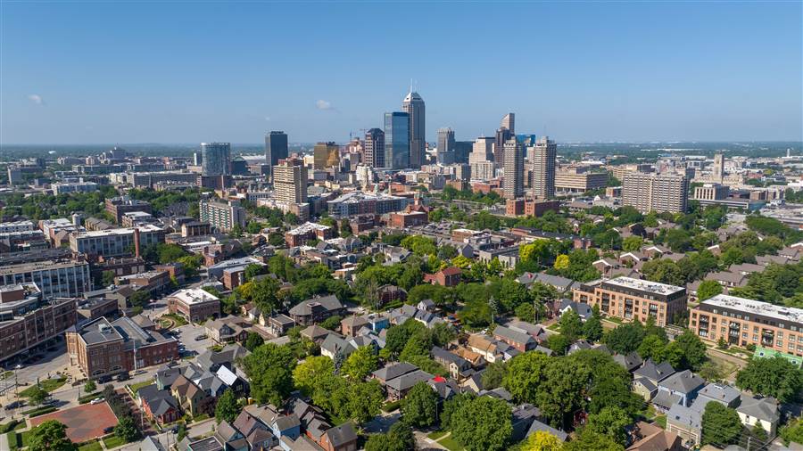 Aerial view of downtown Indianapolis skyline beyond residential streets