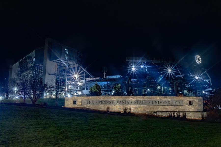Beaver Stadium entrance sign at Penn State lit up at night