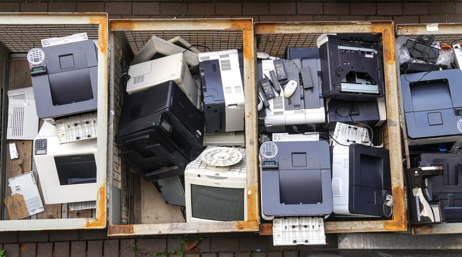 Bins of decommissioned printers and computer equipment awaiting disposal