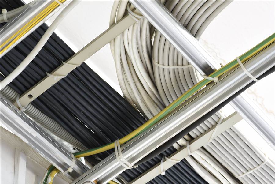 Bundled network cabling organized along a ceiling cable tray