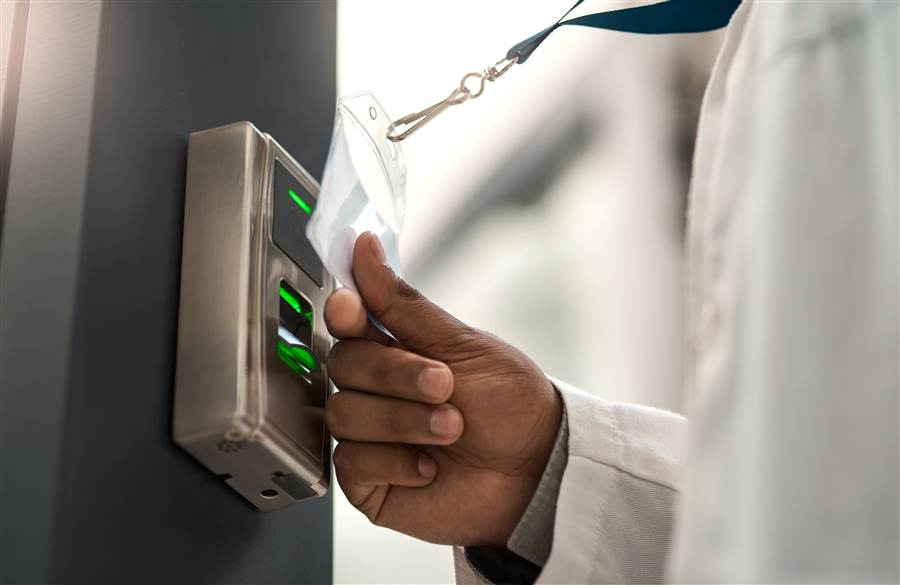 Employee badging in at a keycard entry access reader